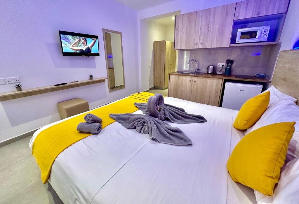 pacious Superior Double hotel room with modern decor, featuring a comfortable double bed and large window with natural light.