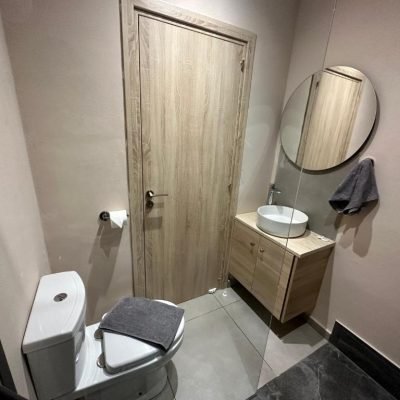 Renovated, clean hotel bathroom with modern fixtures and bright lighting.