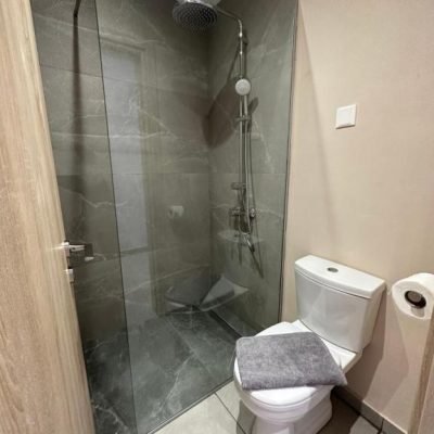 Renovated, clean hotel bathroom with modern fixtures and bright lighting.