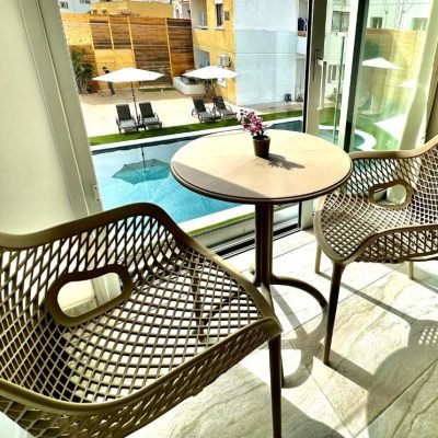 Superior hotel room with a pool view and a comfortable bed.