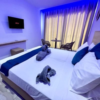 Superior hotel room with a large bed and modern decor.