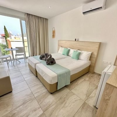 Elegant Superior Room with modern design, featuring a comfortable bed, stylish furnishings, and natural light from large windows.