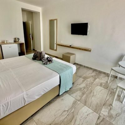 Superior hotel room with a large bed and modern decor.