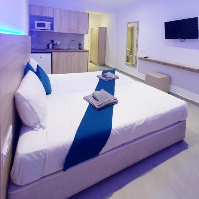 Superior Studio with modern design, cozy bed, and small kitchenette.