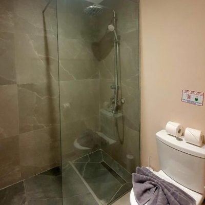 Renovated, clean hotel bathroom with modern fixtures and bright lighting.