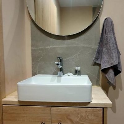 Renovated, clean hotel bathroom with modern fixtures and bright lighting.