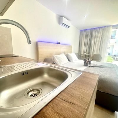 Superior Studio with modern design, cozy bed, and small kitchenette.