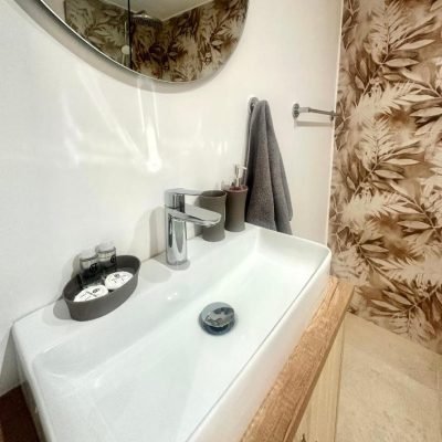 Clean and bright hotel bathroom with modern amenities.
